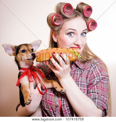 Beautiful young woman having fun eating hot-dog