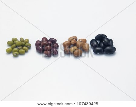 assorted beans arranged in a row