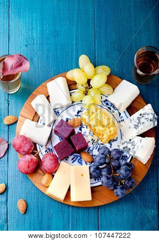 Cheese plate with fresh grape, honey, nuts,plum jelly, marmalade