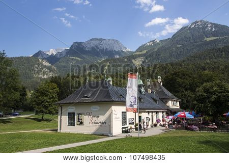 KOENIGSSEE, GERMANY - AUGUST 13, 2015: Exhibition building as a contribute Romy Scheider a famous actress with the mountains around the Koenigssee in the background
