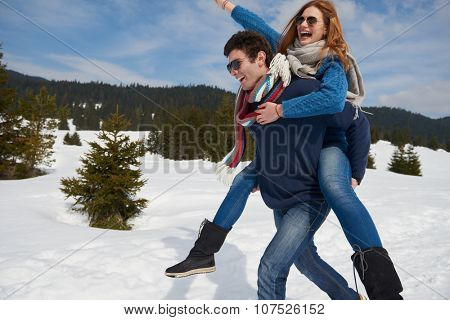 romantic winter  scene, happy young couple having fun on fresh show on winter vacatio, mountain nature landscape