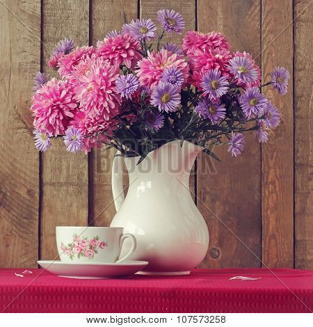Still Life With A Bouquet Of Autumn Flowers And A Retro A Cup.