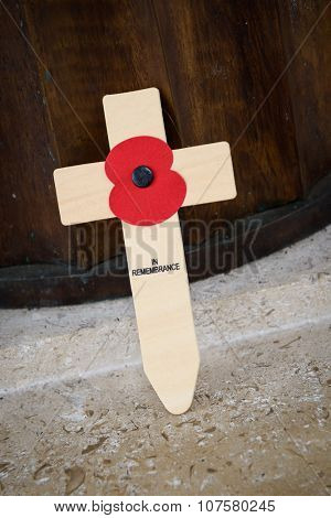 LONDON, UK - CIRCA JANUARY 2013: A poppy on a wooden cross at Bomber Command Memorial.
