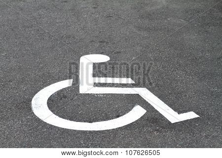 Closeup Invalid Sign On Parking Asphalt