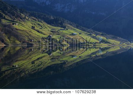 Farmland With Houses Reflecting In Lake Wagital