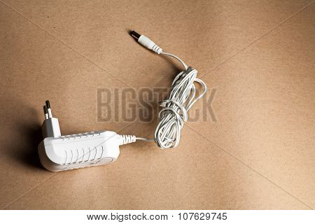 Laptop AC adapter on brown craft paper