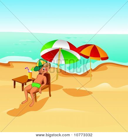 Boy under umbrella on the beach