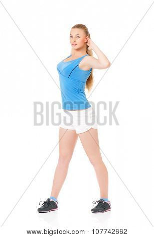 Smiley young sportswoman doing stretching exorcises, isolated on white background
