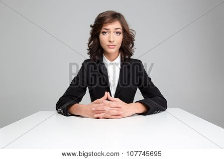 Portrait of sad disapointed pretty curly woman in black jacket