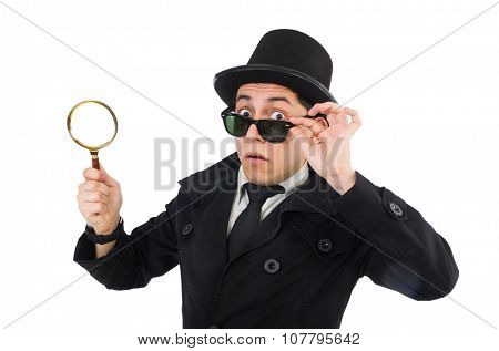 Young detective in black coat holding magnifying glass isolated on white