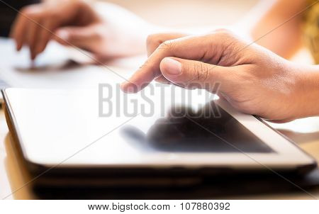 Hand Touching Screen On Modern Digital Tablet Pc. Selective Focus On Finger. With Hand Playing Lapto
