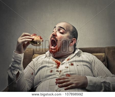 Voracious man eating a hamburger