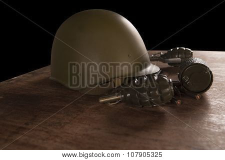 Military Helmet, Hand Grenades And Bullets On Table