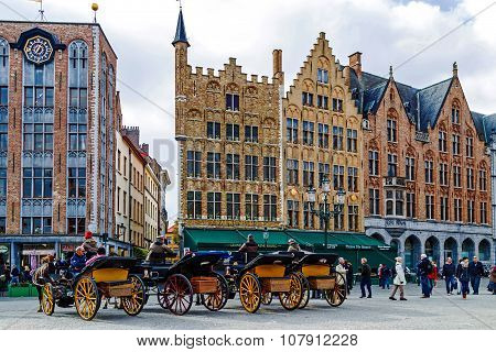Horse-drawn Carriage With Tourists In Grote Markt, Brugge, Belgium