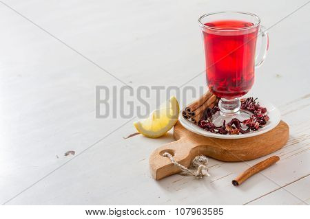 Karkade tea on white wood background