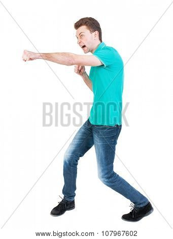 skinny guy funny fights waving his arms and legs. Isolated over white background. Funny guy clumsily boxing. Clumsily fighting man in a green jacket.