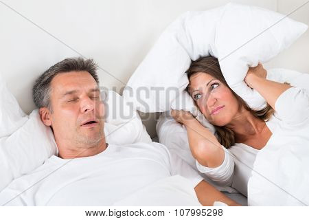 Angry Woman Trying To Sleep With Snoring Man