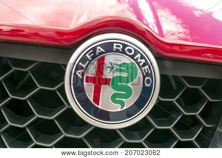 BAD NAUHEIM GERMANY AUGUST 2017: ALFA ROMEO logo on a red car.