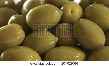 Large shiny green olives macro for background