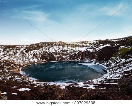 Landscape of Kerio crater frozen lake in Iceland. Geothermal area in winter