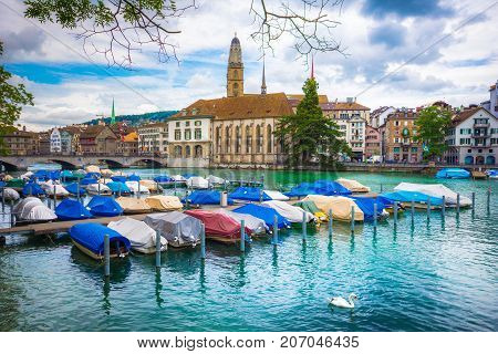 Beautiful view of historic city center of Zurich with love pad locks on the bars and famous Fraumunster Church and Munsterbucke crossing river Limmat, Canton of Zurich, Switzerland on July 10, 2017.