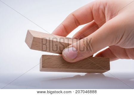 Hand Holding Wooden Domino
