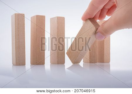 Hand Holding Wooden Domino