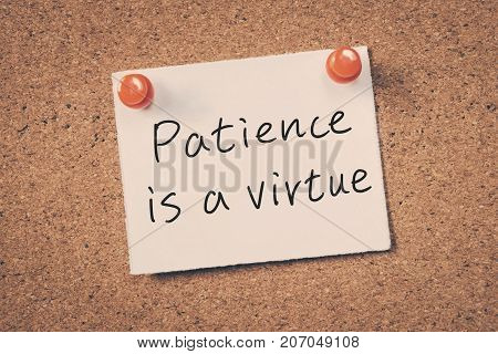Patience Is A Virtue Reminder Message On A Cork Board