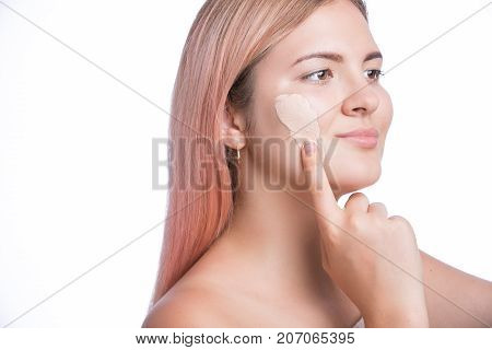 Young pretty girl with foundation on her face