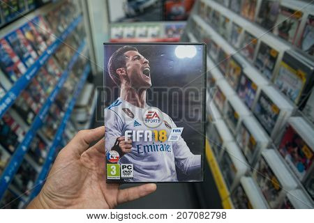 Bratislava, Slovakia, october 2 2017: Man holding Fifa 18 videogame on PC in store