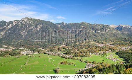 Aerial landscape with fresh green grazing meadow in Bavarian Alpine valley