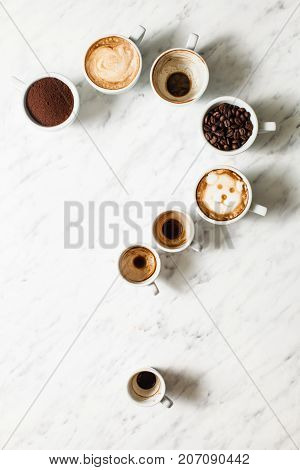 Set of different coffee cups as a question mark, top view , top view. Phylosophy of life concept