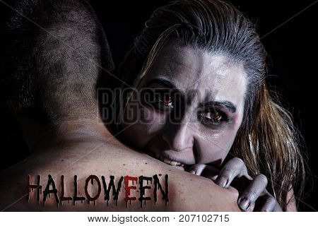 A female vampire biting in a man's neck