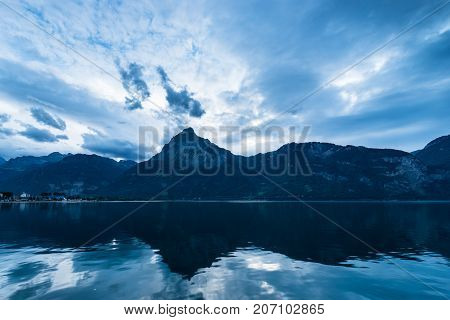 The wind over the mountains and the lake brought cumulus and thunderclouds. Lake Lucerne with Oberbauenstock (2116m). Switzerland.