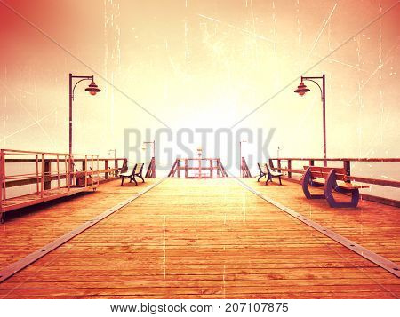 Long Touristic Mole Within Autumn Misty Morning. Wet And Slippery Wooden Floor