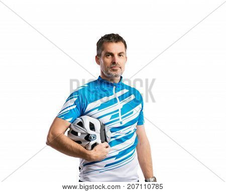 Mature handsome hipster man in blue sports t-shirt and helmet. Studio shot on white background, isolated.