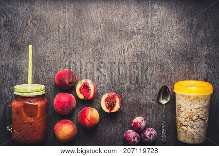 Fruit Smoothies. Peach and plum smoothie. Peach, plum and oatmeal. Delicious and healthy breakfast on wooden background. Top view. Copy space. Still life. Flat lay