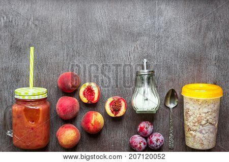 Fruit Smoothies. Peach and plum smoothie. Peach, plum and oatmeal. Delicious and healthy breakfast on wooden background. Top view. Copy space. Still life. Flat lay