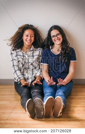 Portrait of teenage girls best friends having fun in photo studio session