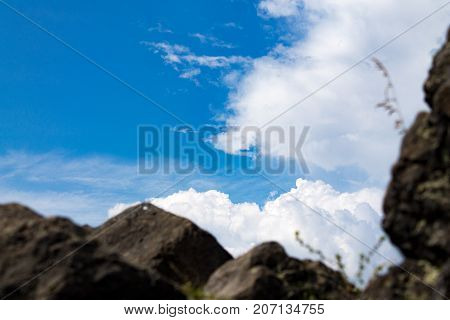 Stone rocks in the foreground sky in focus on the background