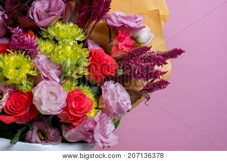 A Beautiful Bouquet Of Pink Eustoms, A Yellow Chrysanthemum, A Red And Pink Rose, On A Pink Backgrou