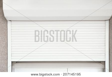 Window with half-closed roller shutter, closeup