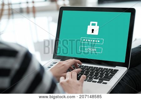 Hand tying labtop computer with password login on screen cyber security concept