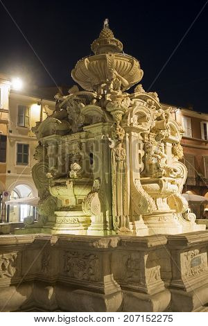 Cesena (Emilia Romagna Italy): the monumental fountain in the main square of the city at evening