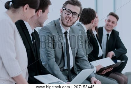 business team with laptop and documents sitting in the lobby bef