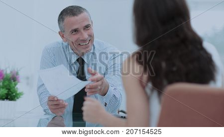 boss discusses with the assistant business documents in the offi