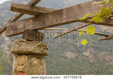 detail of a pylon in stone and lime of the vineyards  of Carema,Piedmont,Italy / a pylon stone and lime with the span on which the pergola of vineyards is supported