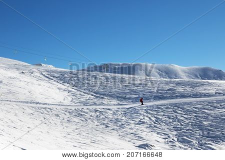 Skier Downhill On Ski Slope At Nice Sun Morning