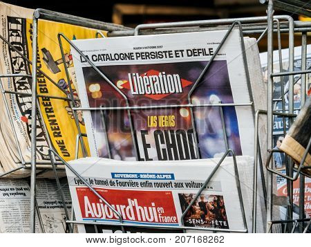 PARIS FRANCE - OCT 3 2017: Liberation French newspaper with socking title and photo at press kiosk about the 2017 Las Vegas Strip shooting in United States with about 60 fatalities and 527 injuries