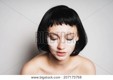 girl with a mask on her face closed her eyes